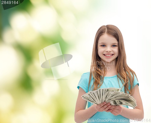 Image of smiling little girl with dollar cash money