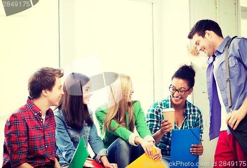 Image of students communicating and laughing at school