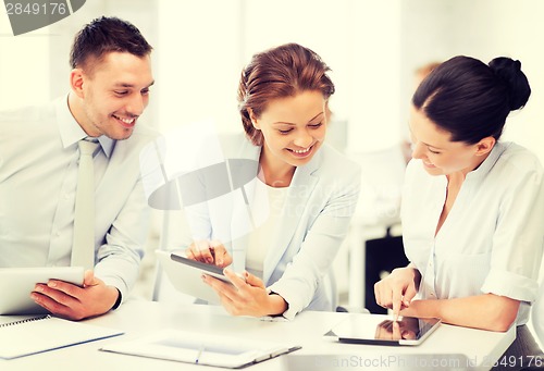 Image of business team working with tablet pcs in office