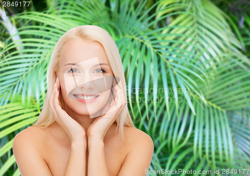 Image of beautiful woman touching her face skin