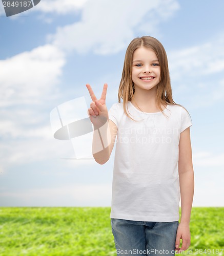 Image of little girl in white t-shirt showing peace gesture