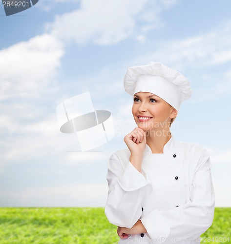 Image of smiling female chef dreaming