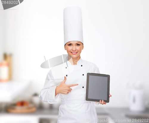 Image of smiling female chef with tablet pc blank screen