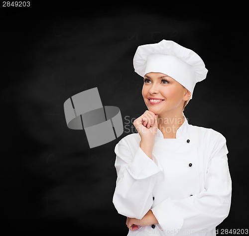 Image of smiling female chef dreaming