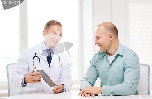 Image of doctor with tablet pc and patient in hospital