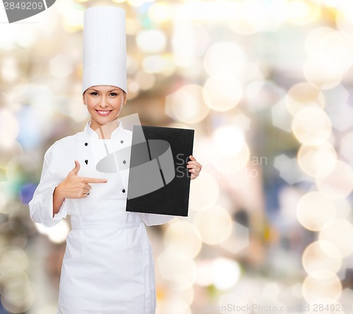 Image of smiling female chef with black blank paper