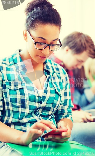 Image of student girl with smartphone at school