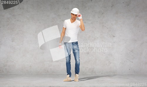 Image of handsome builder in helmet and gloves