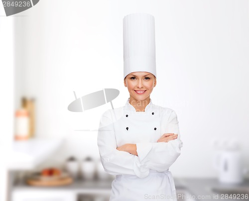 Image of smiling female chef with crossed arms