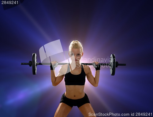 Image of sporty woman exercising with barbell