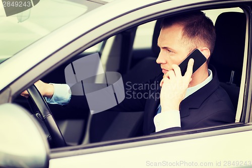 Image of man using phone while driving the car