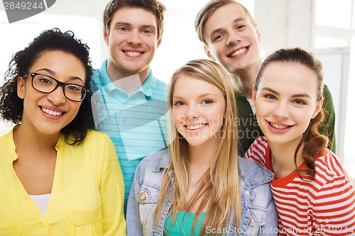 Image of group of smiling people at school or home