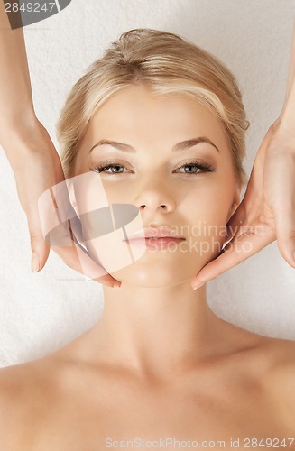 Image of beautiful woman in massage salon