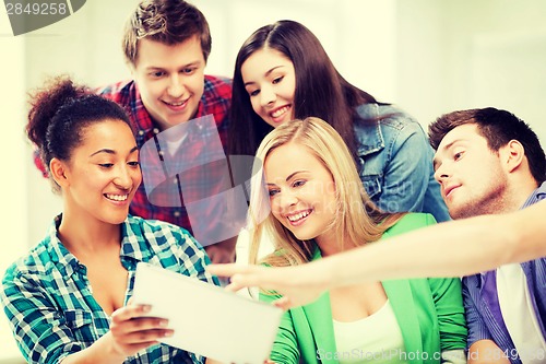 Image of students looking at tablet pc at school