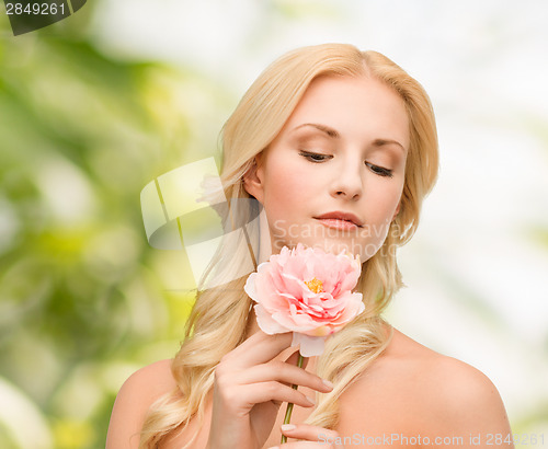 Image of lovely woman with peony flower