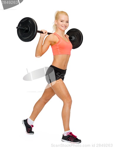 Image of smiling sporty woman exercising with barbell