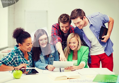 Image of students looking at tablet pc at school