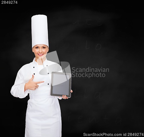 Image of smiling female chef with tablet pc blank screen
