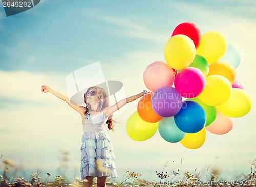 Image of happy girl with colorful balloons