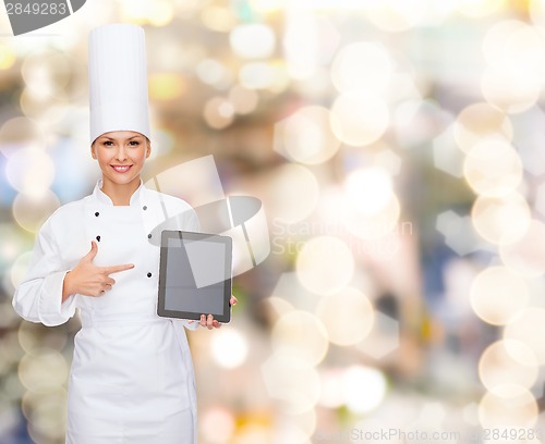 Image of smiling female chef with tablet pc blank screen