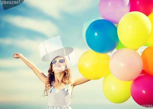 Image of happy girl with colorful balloons