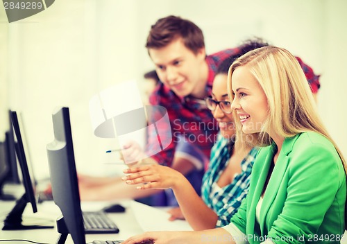 Image of students with computer studying at school