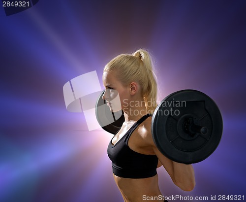 Image of sporty woman exercising with barbell