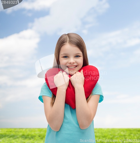 Image of smiling little girl with red heart