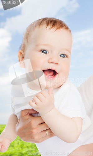 Image of close up of mother holding smiling baby