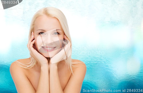Image of beautiful woman touching her face skin