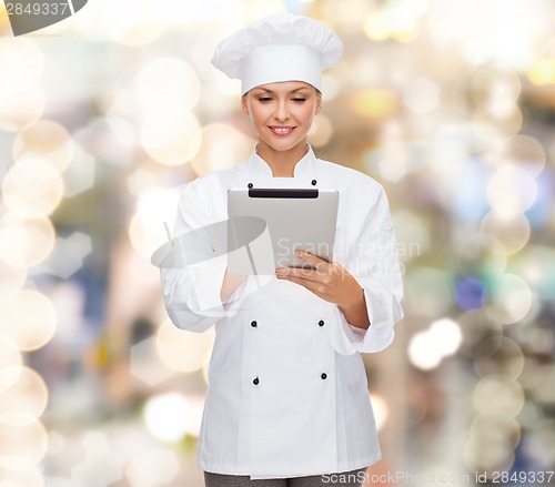 Image of smiling female chef with tablet pc computer