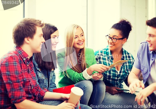 Image of students communicating and laughing at school