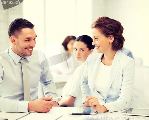 Image of usiness colleagues talking in office