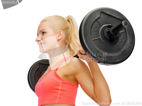 Image of smiling sporty woman exercising with barbell