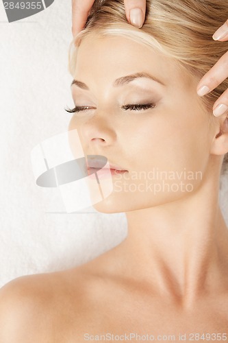 Image of beautiful woman in massage salon