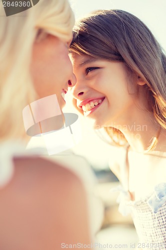 Image of happy mother and child girl outdoors