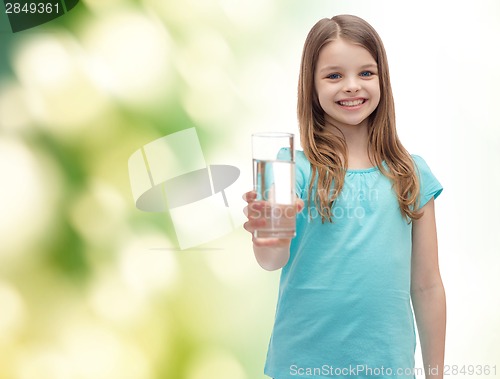 Image of smiling little girl giving glass of water