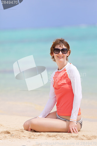 Image of woman in rashguard at the beach
