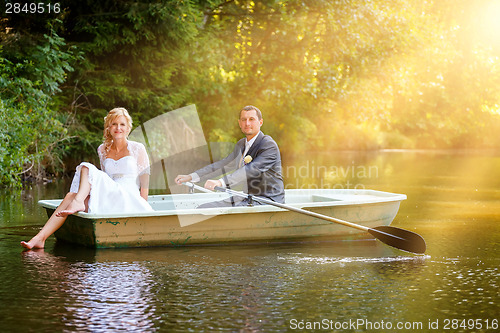 Image of Young just married bride and groom on boat