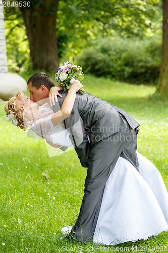 Image of beautiful young wedding couple kissing