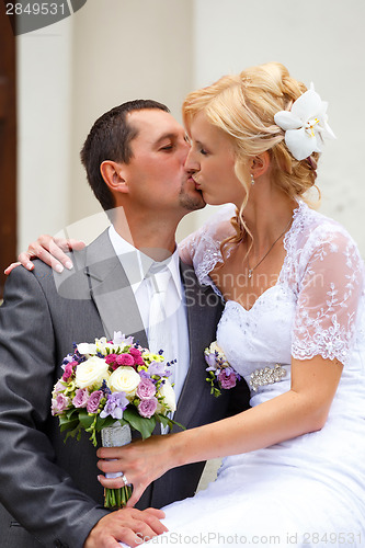 Image of beautiful young wedding couple kissing