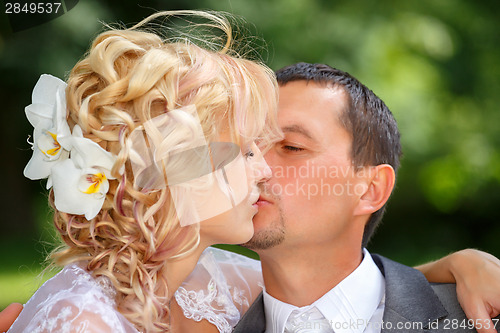 Image of beautiful young wedding couple kissing