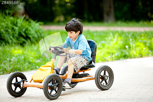 Image of boy rides a velomobile