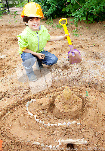 Image of boy builder in a protective helmet