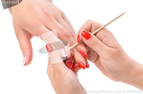 Image of manicure applying - cleaning the cuticles 