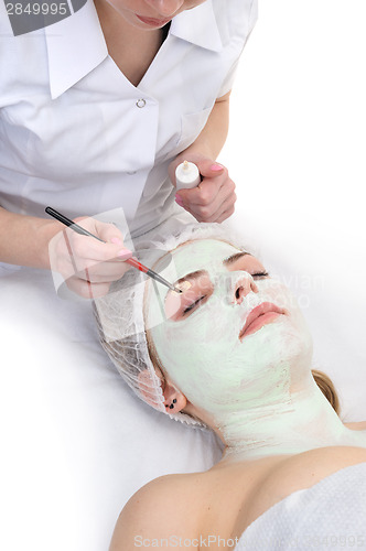 Image of beauty salon, eyes facial mask applying