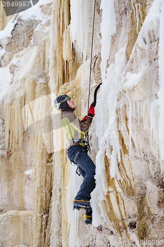 Image of Young man climbing the ice