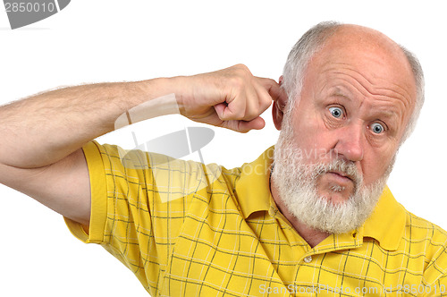 Image of goofy bald senior man's picking his ear