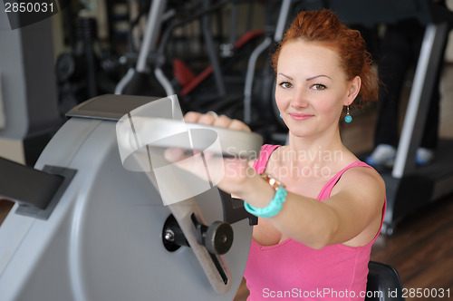 Image of girl doing hands spinning machine workout