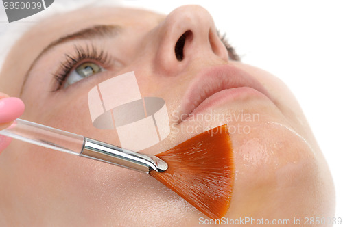 Image of facial peeling mask applying